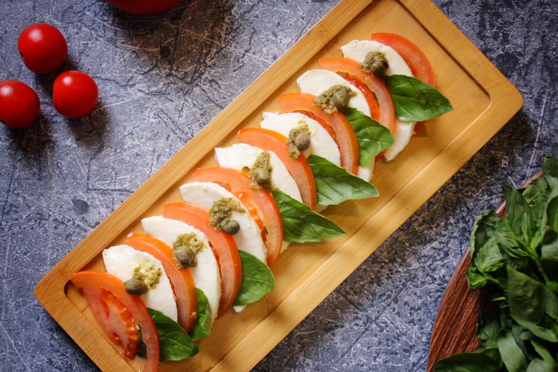Caprese salad with fresh tomato and mozzarella at pizza factory