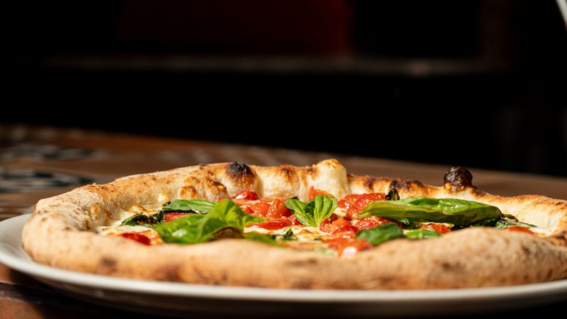 Classic Margherita pizza with fresh basil at pizza factory