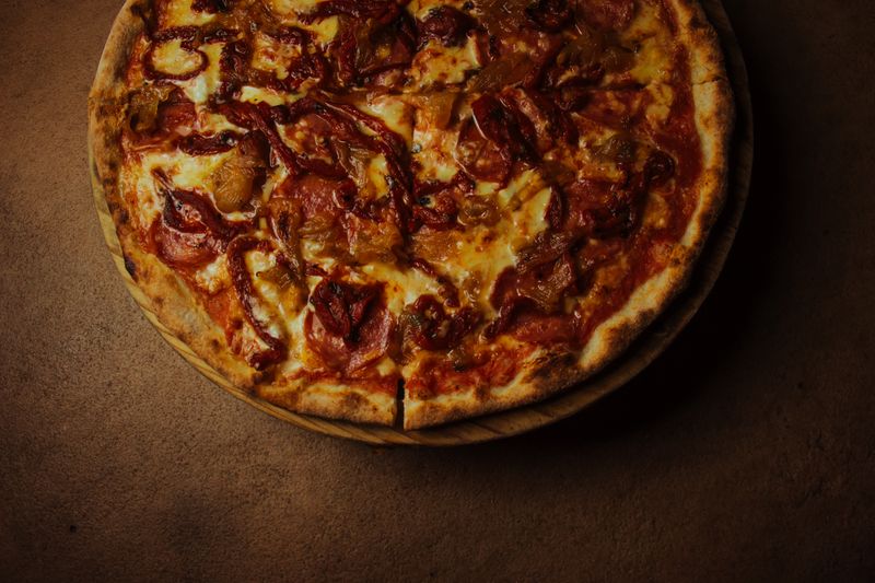 Spicy Diablo pizza with jalapeños and hot sauce at pizza factory