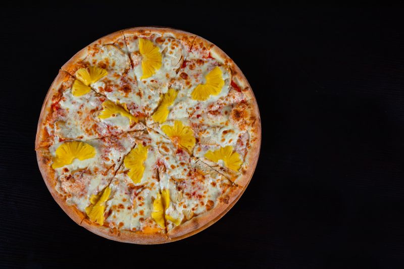 Hawaiian pizza with ham and pineapple at pizza factory